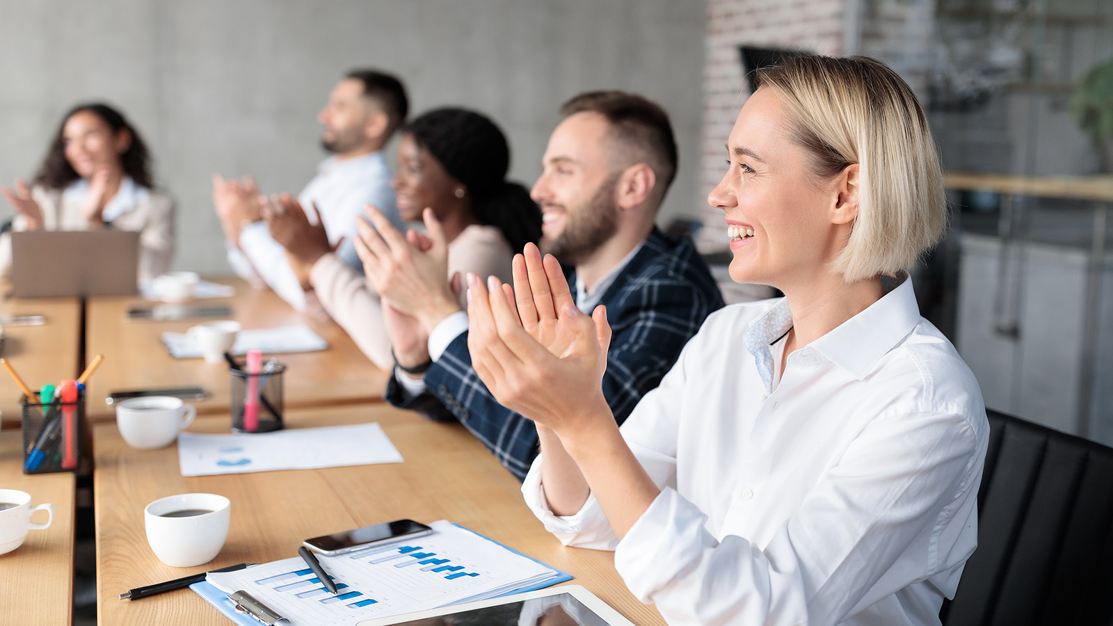 bigstock-Joyful-Coworkers-Applauding-Ce-398215397 (1)-2